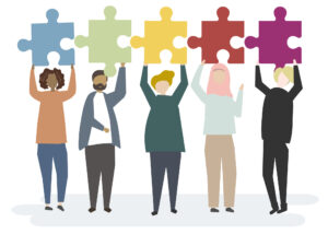 Family Engagement 3 - five multiethnic people holding up multi-colored puzzle pieces